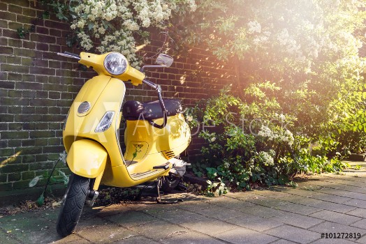Bild på Yellow scooter parked